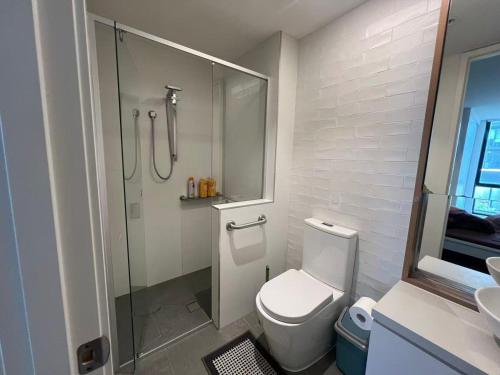 a bathroom with a shower and a toilet and a sink at Boxhill home in Box Hill