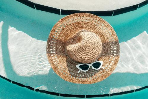 a straw hat and sunglasses sitting on the water at Casa Morada in Islamorada