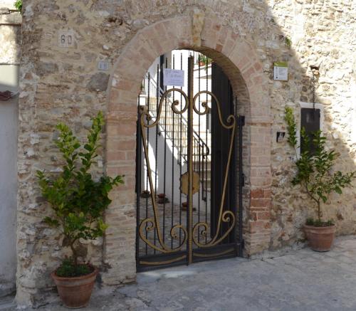 an entrance to a stone building with an iron gate at Residenza La Nivera in Miglionico