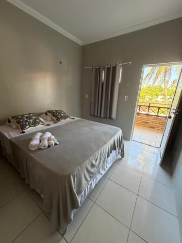 a bedroom with a bed with two stuffed animals on it at Kairos Beach Hotel in Camocim