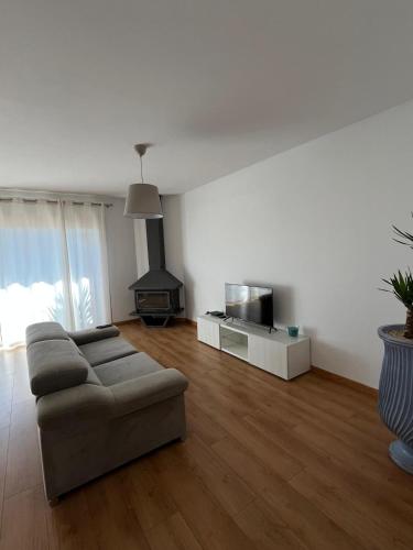 a living room with a couch and a stove at Alojamento Local Pando in Vila do Conde