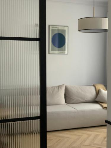 a living room with a couch and a window at Moon Deer in Jelenia Góra