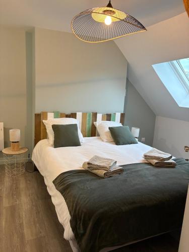 a bedroom with two beds and a ceiling at Escapade à Pierry in La Celle-sous-Gouzon