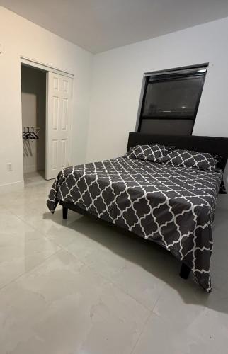 a bedroom with a bed with a black and white comforter at 2 bedroom 2467 in Miami