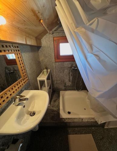 a bathroom with a sink and a toilet and a tub at Rustico Guidotti in Bellinzona