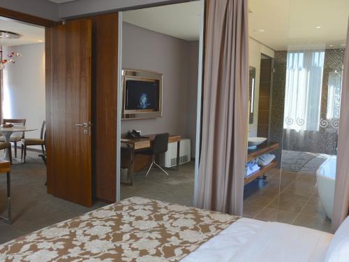 a hotel room with a bed and a bathroom at Atlantida Boutique Hotel in Rogaška Slatina
