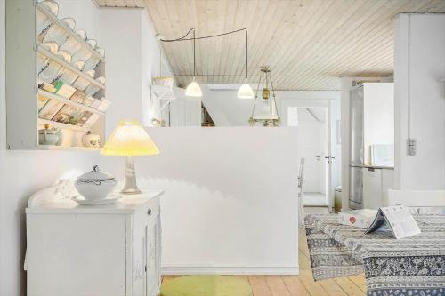 a room with a table with a lamp on it at 872-Bedsted-Thy-Lyngbyvej-25 in Bedsted Thy