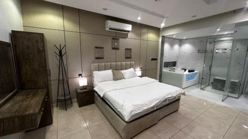 a bedroom with a large bed and a shower at شاليه ايلان المدينة المنورة in Medina