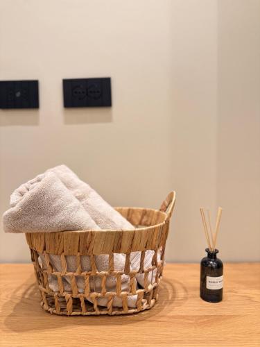 a basket on a table next to a bottle of soap at Vog Villa in Tirana