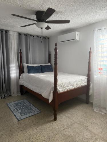 a bedroom with a bed with a ceiling fan at Caguas Like Home in Caguas