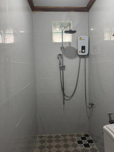 a shower stall in a bathroom with a toilet at Sabai Sabai Backpackers Hostel in Luang Prabang