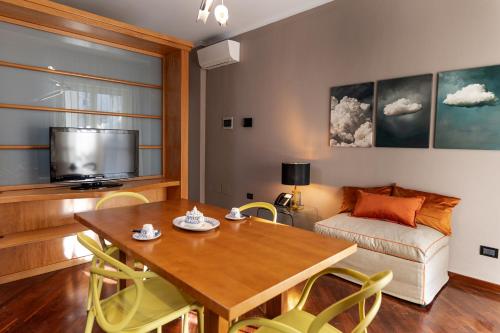 a living room with a table and a couch at Apulia Re' Aparthotel & Suites in Bari