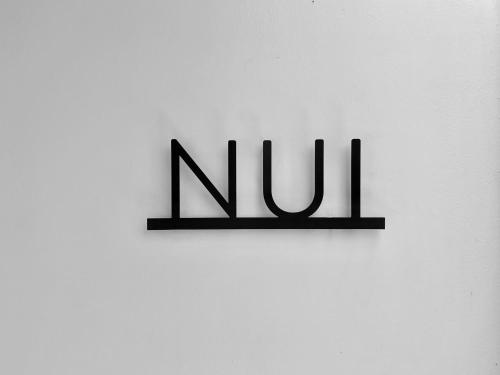 a sign that says no on a white wall at Honu Villas - Nui in Nosara