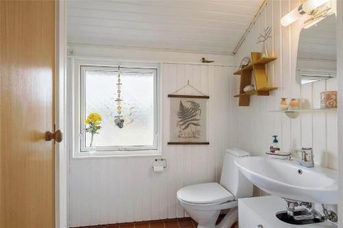 een badkamer met toilet, wastafel en raam bij 802-Thisted-Pighvarvej-22 in Thisted