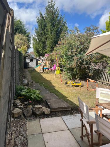 a backyard with a play yard with a playground at Edwardian House in Stamford in Ryhall