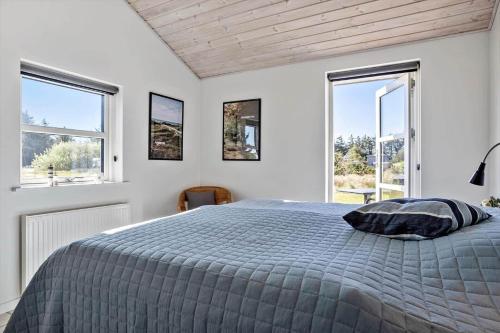 a white bedroom with a bed and two windows at 332-Thisted-Kristinesvej-32 in Thisted