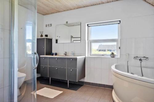 a bathroom with a tub and a sink and a toilet at 332-Thisted-Kristinesvej-32 in Thisted