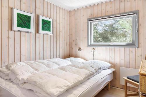 a large white bed in a room with a window at 862-Thisted-Nordsovej-162 in Thisted