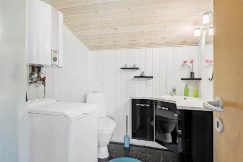 a white bathroom with a toilet and a sink at 710-Thisted-Klitrosevej-10 in Thisted