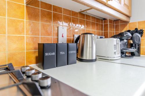a kitchen counter with appliances on a counter top at Modern Three Bedroom House Free parking wifi in Bristol