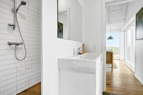 a white bathroom with a sink and a shower at 1053-Thisted-Kraenhavs-Sti-8 in Torsted