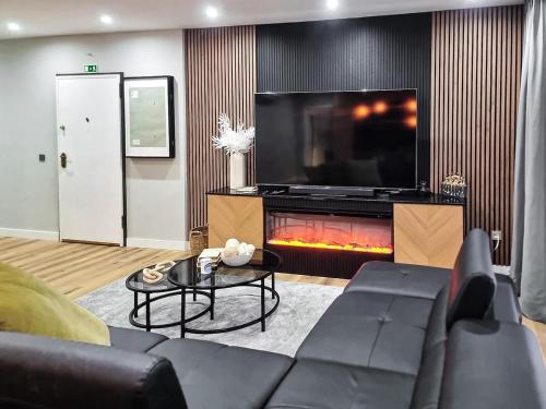 a living room with a couch and a fire place at Spacious Home in Vila Nova de Gaia Porto