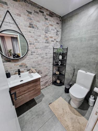 a bathroom with a white toilet and a mirror at Spacious Home in Vila Nova de Gaia Porto