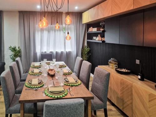 a dining room with a table and chairs at Spacious Home in Vila Nova de Gaia Porto