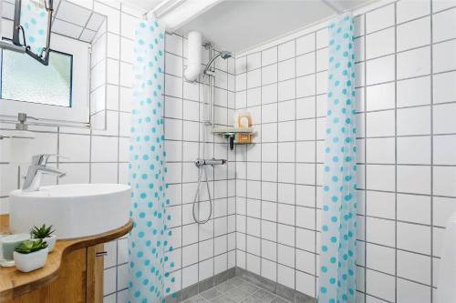 a white bathroom with a shower and a sink at 204-Vestervig-Lodbjergvej-4 in Vestervig