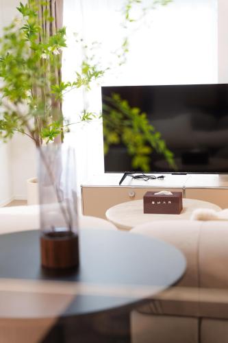 a vase sitting on a table next to a couch at Hotel ONE in Tokyo