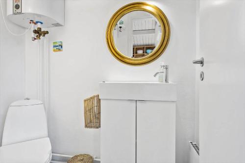 a white bathroom with a sink and a mirror at 1309-Thisted-Blabaervej-2 in Thisted