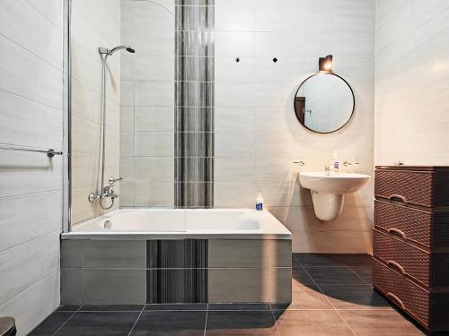 a bathroom with a bath tub and a sink at Speranza in Il-Gżira