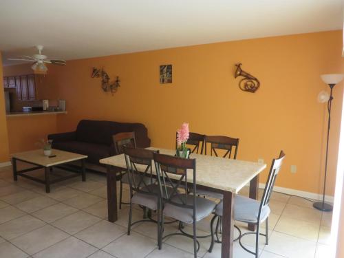 a living room with a table and a couch at Close to Store & Airport in Kenner