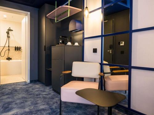 a salon with a chair and a barber shop at Mercure Bucharest Cantemir in Bucharest