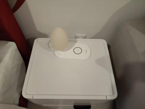 a white toilet with a egg on top of it at Kampung Marsa at Majestic Residence, Kuala Lumpur in Kuala Lumpur