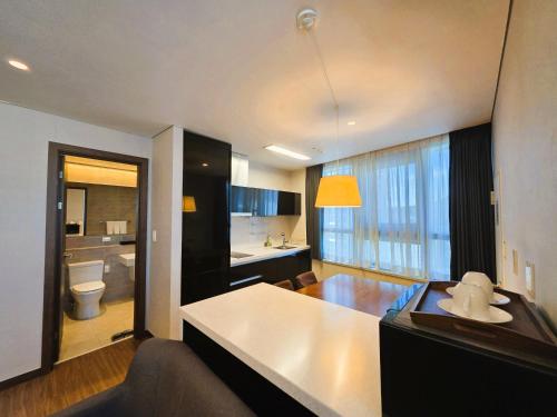 a living room with a kitchen and a bathroom at W Residence Hotel in Busan