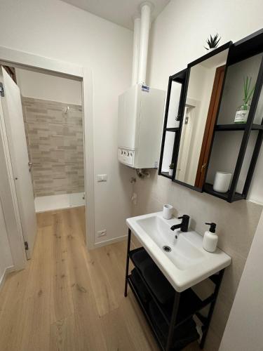 a bathroom with a white sink and a mirror at App Borsa Trieste in Trieste