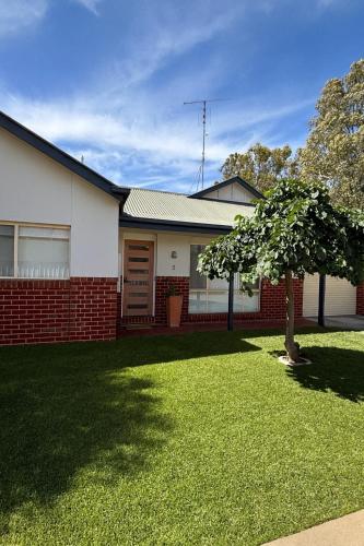 a house with a tree in the front yard at The Terrace - Echuca in Echuca