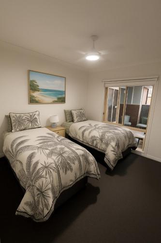 a bedroom with two beds and a window at The Terrace - Echuca in Echuca