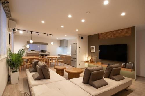 a living room with a couch and a dining room at hazuki in Asahikawa