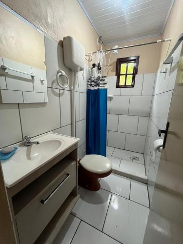 a bathroom with a sink and a toilet and a shower at Recanto do descanso in Pinhal