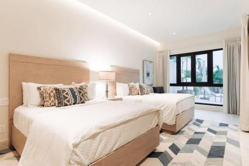 a bedroom with two beds and a large window at Luxury Villa Retreat, Pool in Cabo San Lucas