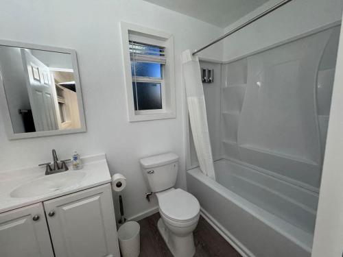 a bathroom with a toilet and a sink and a shower at Bogachiel Den in Forks