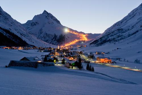 a town in the snow with a mountain in the background at Piz Buin in Kappl