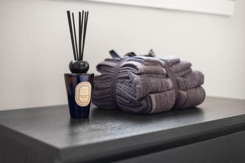 a bundle of yarn sitting next to a bottle of alcohol at Well Presented 3 Bedroom, Grangemouth. in Falkirk