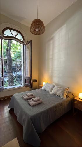 a bedroom with a large bed with two towels on it at Casa Próspera in Buenos Aires