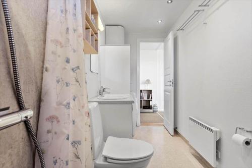 een witte badkamer met een toilet en een wastafel bij 8205-Vordingborg-Strandparken-12 in Vordingborg