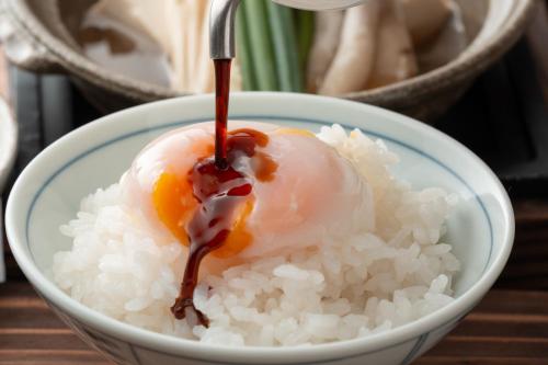 a bowl of rice with an egg on top of it at ShirabuOnsen Higashiya in Yonezawa