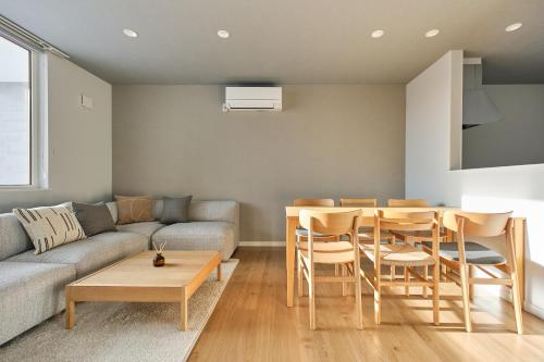 a living room with a couch and a table at 東川Hinna in Higashikawa
