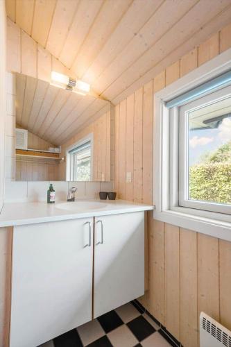 a small kitchen with a sink and a window at R956-Rodvig-Laerkevej-8 in Rødvig